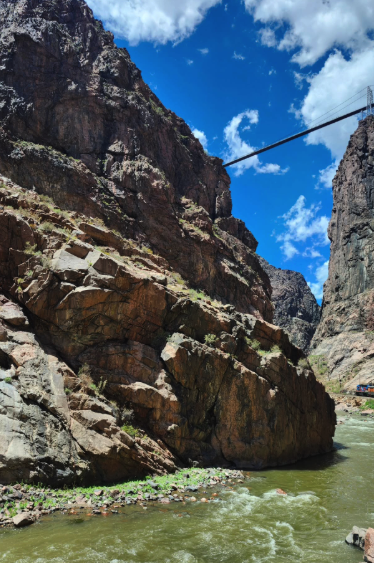 The scenic railroad passing beneath the towering walls of the Royal Gorge